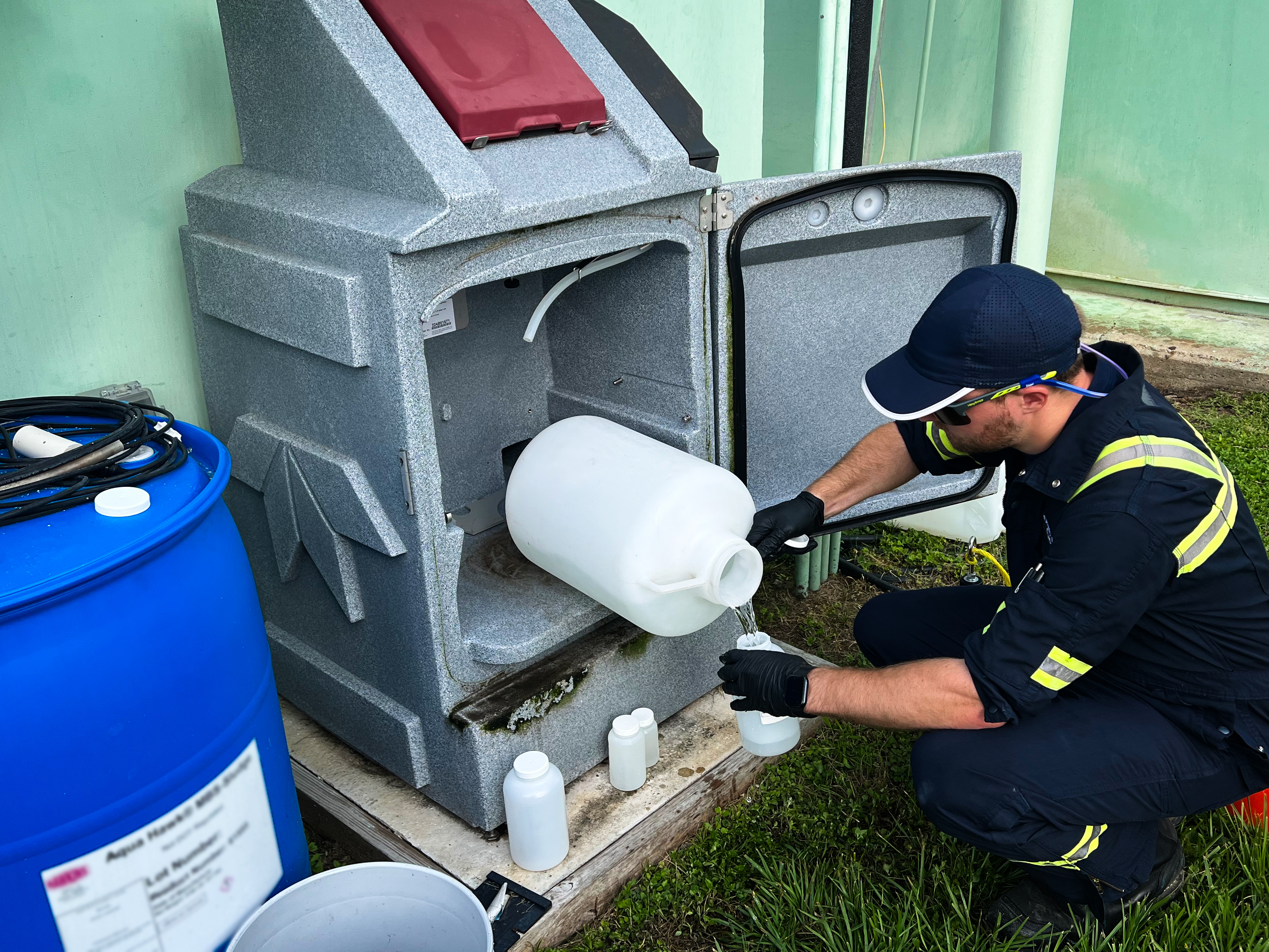 Eastex field technician pulling a process sample at a treatment facility